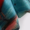 Flamingokuvioinen lyhythihainen kauluspaiti