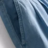 Puuvilladenimiset, laskostetut leveälahkeiset farkut