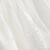 Puuvillainen, brodeerattu peplum-helkainen cami-toppi
