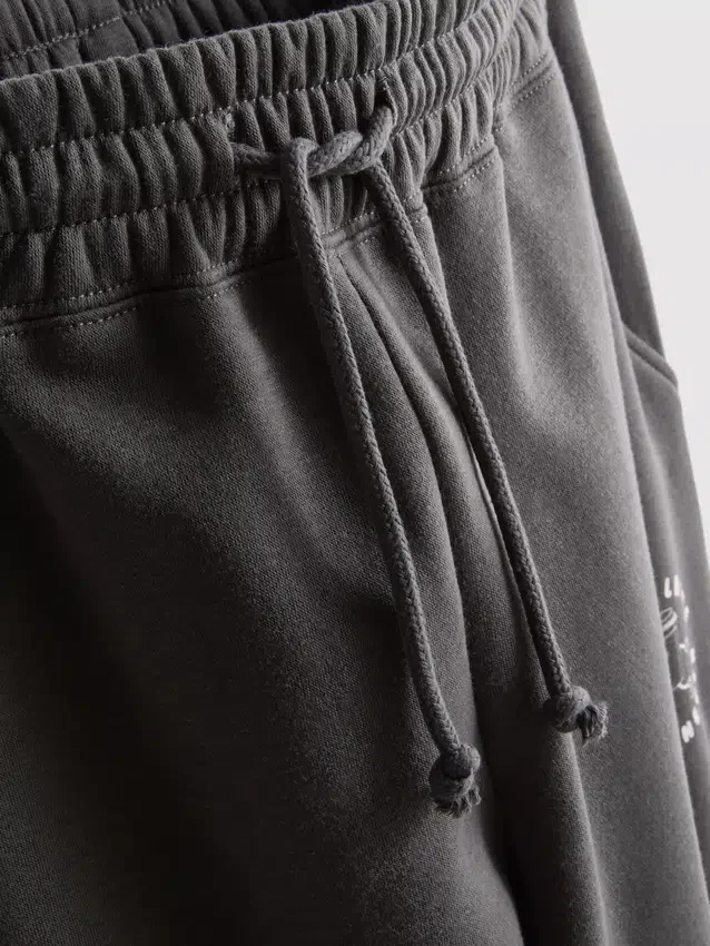 Puuvillaseoksesta valmistetut, painetut collegehousut, joissa on käänteiset lahkeensuut