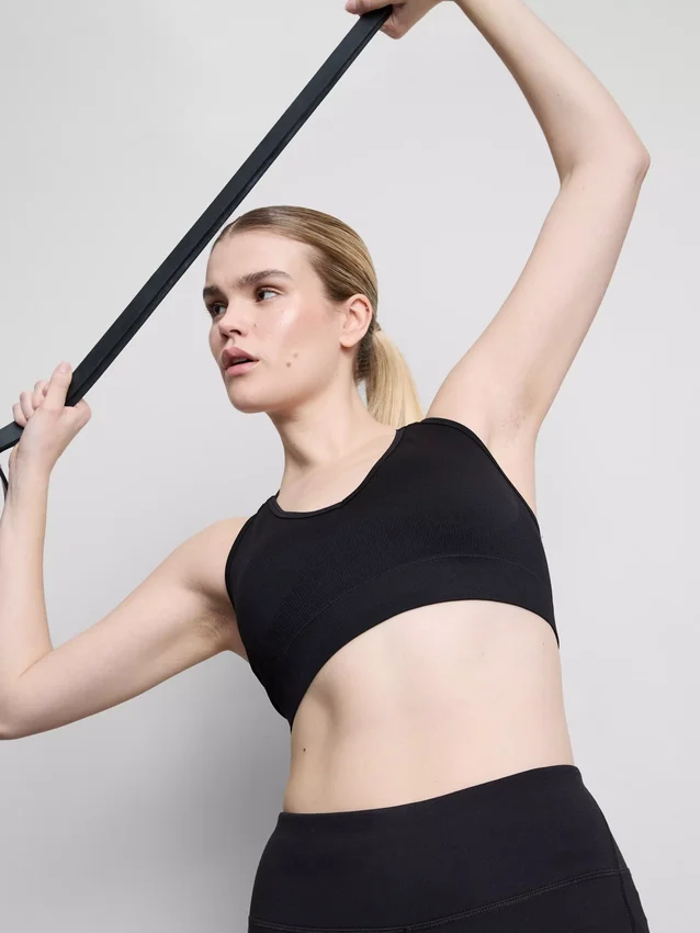 Saumaton, selän takaa ristikkäin menevä urheilullinen crop-toppi