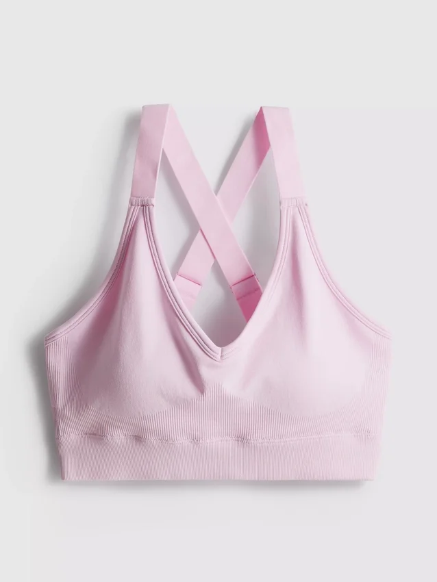 Saumaton, selän takaa ristikkäin menevä urheilullinen crop-toppi