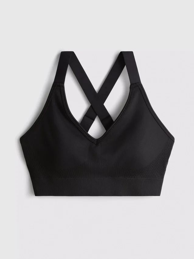 Saumaton, selän takaa ristikkäin menevä urheilullinen crop-toppi