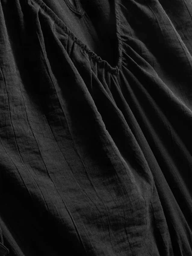 V-kaula-aukkoinen, pallomaiset lahkeet omaava jumpsuit
