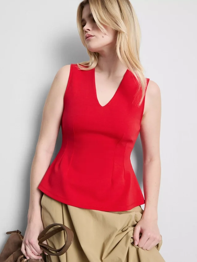 V-kaula-aukkoinen peplum-hihaton toppi