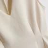 V-kaula-aukkoinen peplum-hihaton toppi